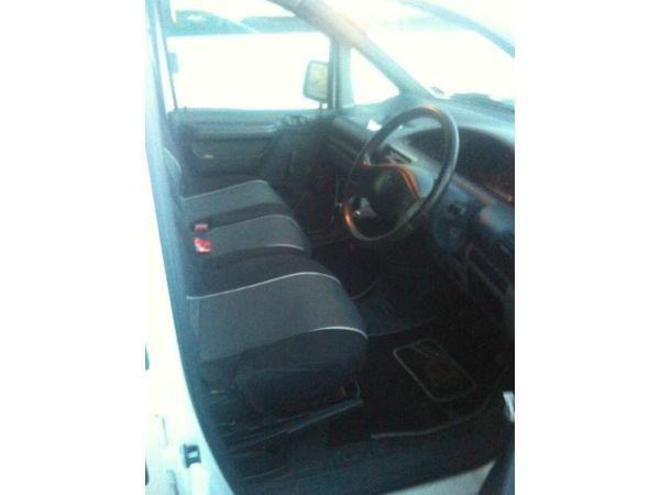 small white Fiat door panel van. 5 seats.